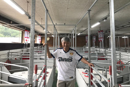 The farmer in front of the farrowing pens